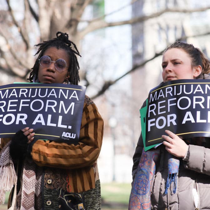A photo of protestors holding signs reading "Marijuana reform for all."